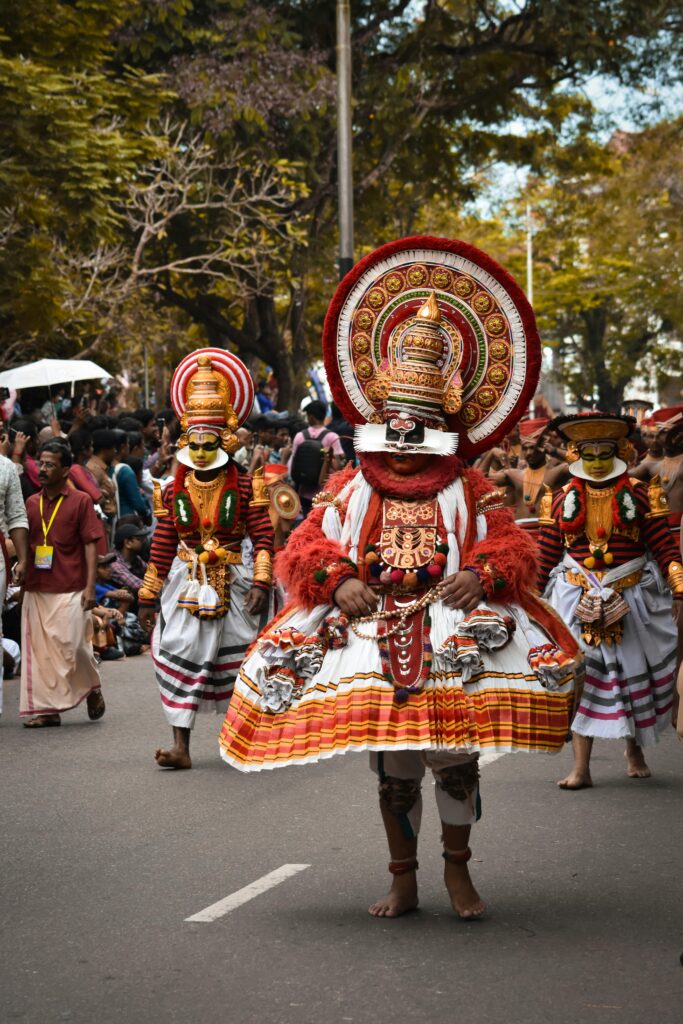 Home Traditional dancers in ornate costumes celebrate a cultural festival in Kerala, India.